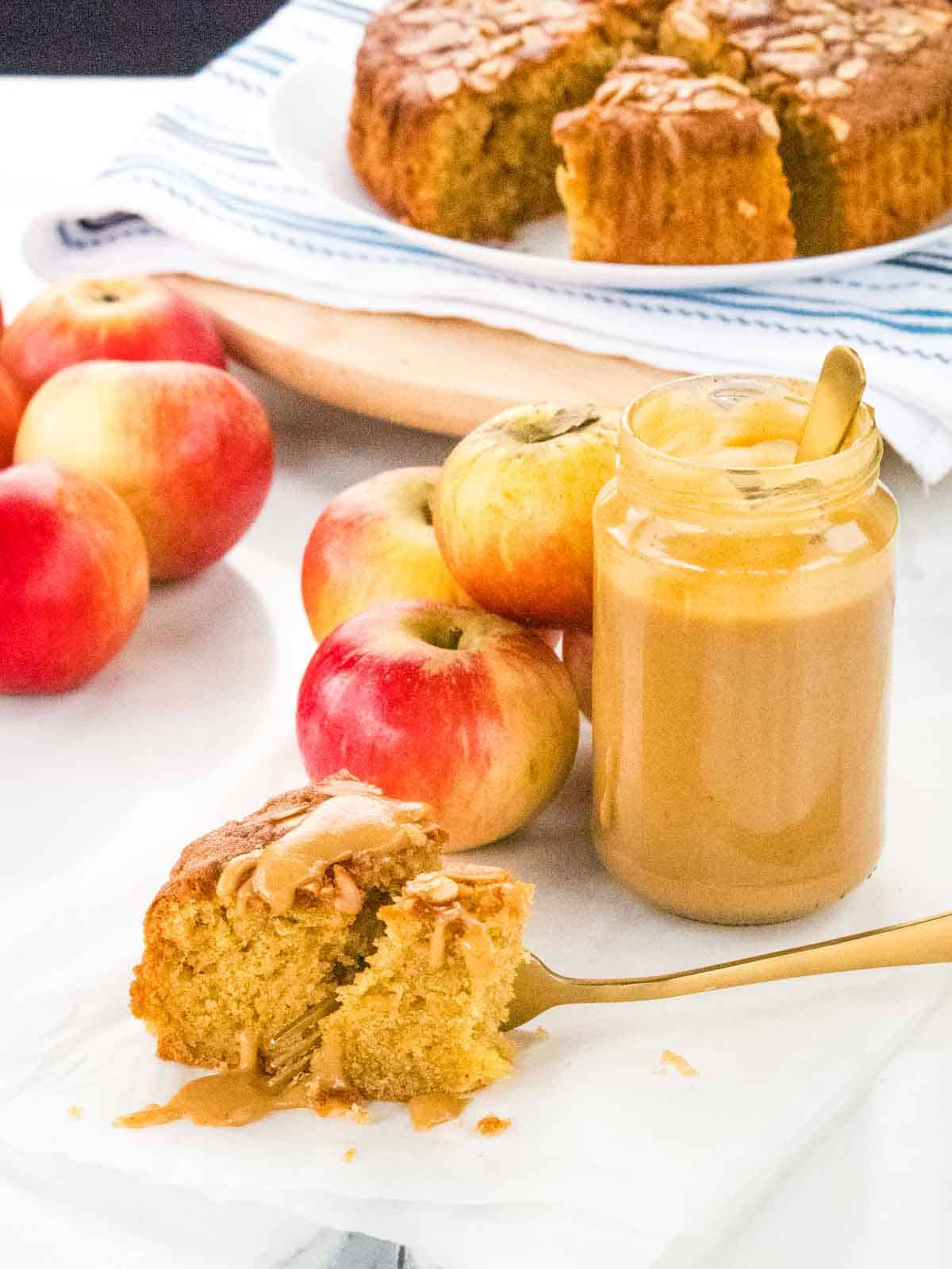 homemade apple and cinnamon curd drizzled on top of a slice of freshly baked apple cake