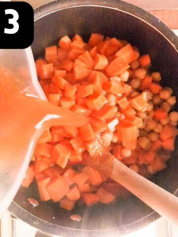 diced carrots, stock and chickpeas added to a soup pot before simmering