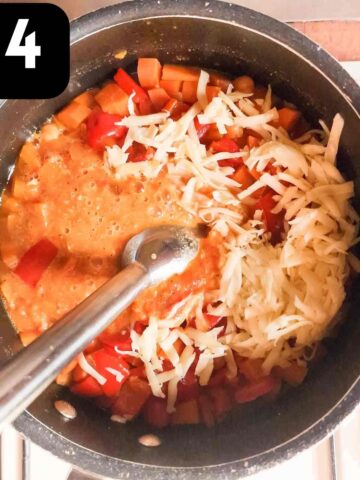 person blended cooked chunky soup until smooth with grated cheese