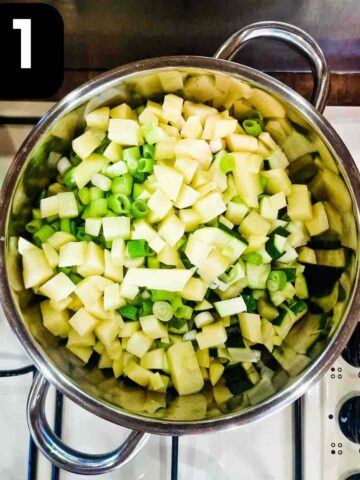 chopped potatoes, zucchini and spring onions in a large pan on stove