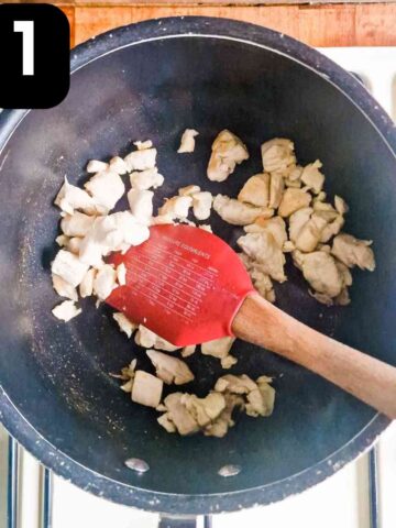 person frying diced chicken in frylight cooking oil spray