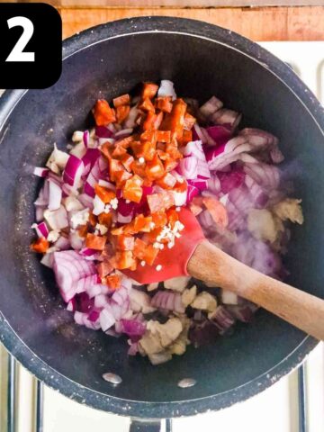 diced vegetables frying in a large saucepan