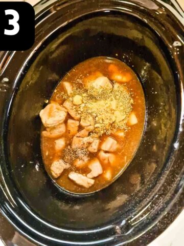 chicken, stock, herbs and spices in slow cooker