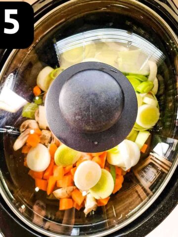 slow cooker with lid on with country vegetables