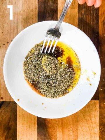 person whisking extra virgin olive oil, herb, pesto and balsamic vinegar for an easy pasta dressing
