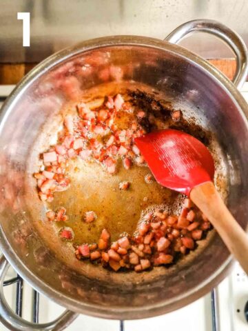 person frying bacon lardons in a large pan with olive oil on stove top