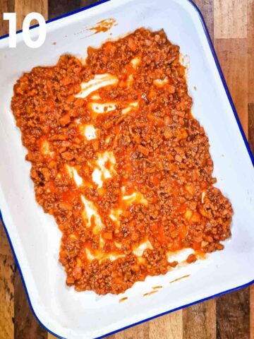 large and deep 9x13" enamel bakin dish with a pork and beef ragu spread at the bottom