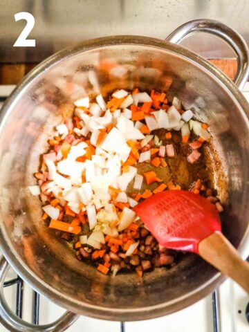 person frying diced onions and carrots in pan with crispy bacon for lasagne meaty sauce base