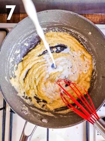 person whisking milk into a cooked butter and flour to make a white sauce for homemade lasagne