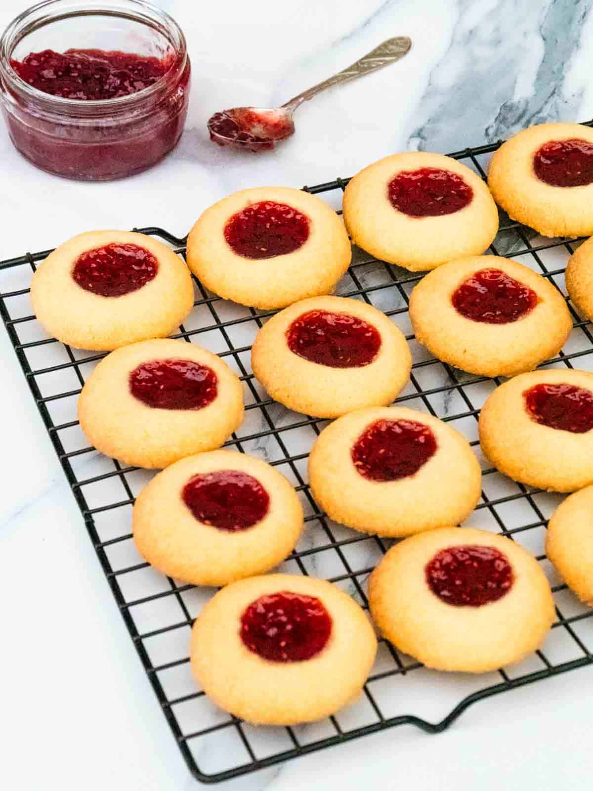 jam thumbprint biscuits cooling on a wire rack