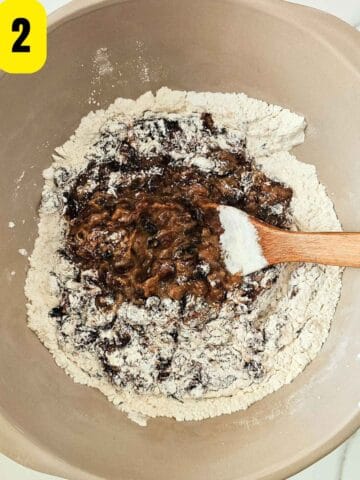 Step 2: Stir self-raising flour into the mincemeat with a wooden spoon.